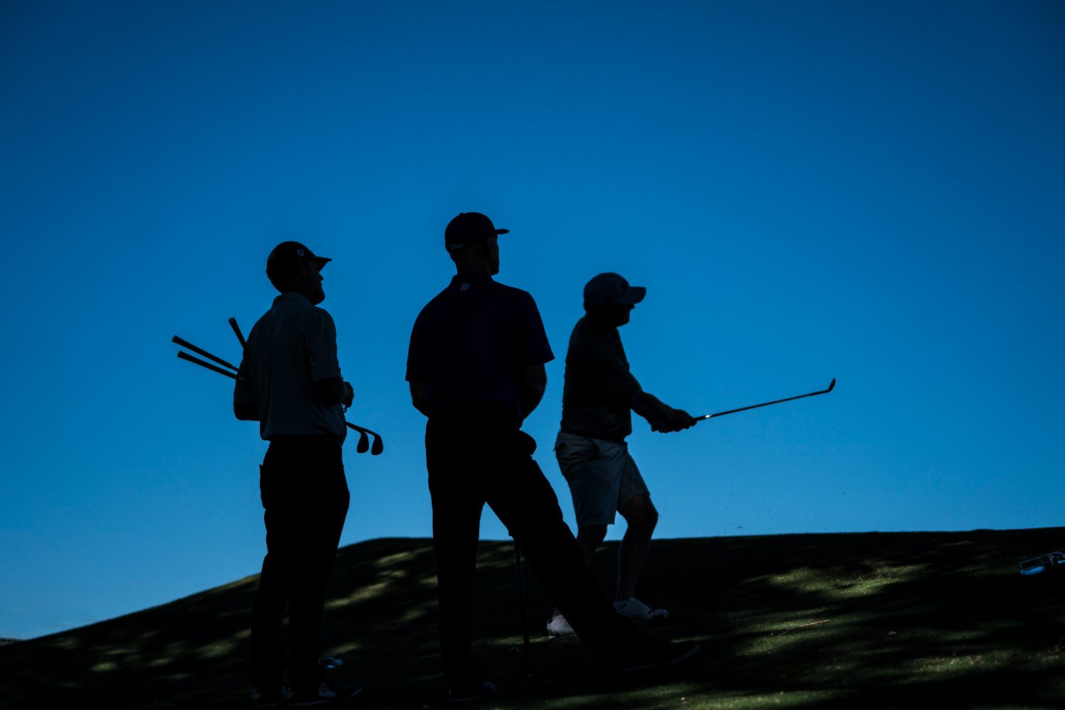 Golfers walking the course at dusk